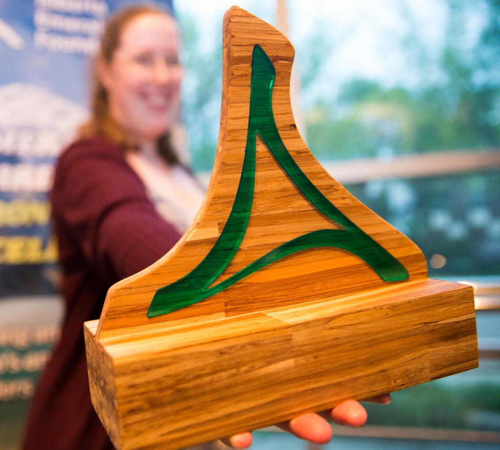 Emerald Award recipient holding trophy received for environmental excellence